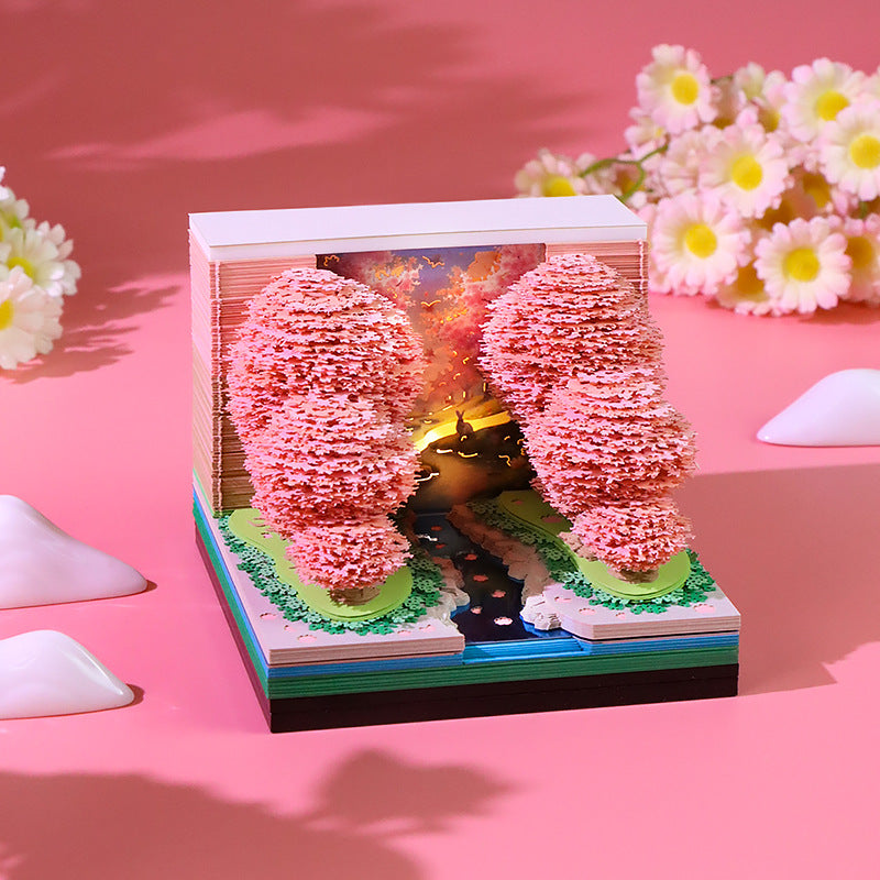 Close-up of Peach Blossom Forest 3D memo pad pages with weekly planner layout
