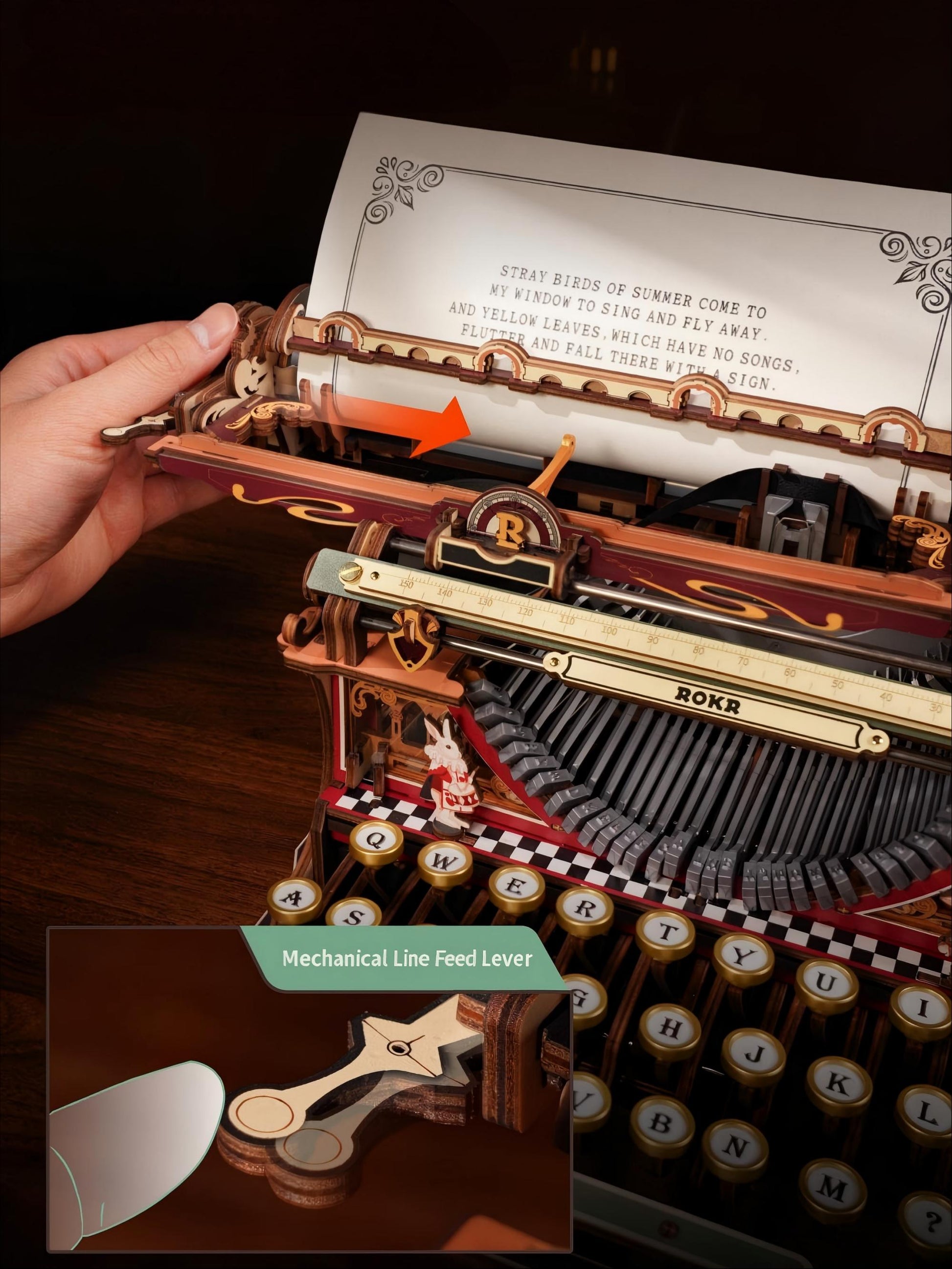 Close-up of a decorative mechanical typewriter with a hand adjusting the paper feed lever, showing detailed brass, wood, and black components. An inset at the bottom highlights the mechanical line feed lever.